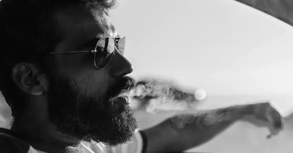 bearded man smoking cigarette