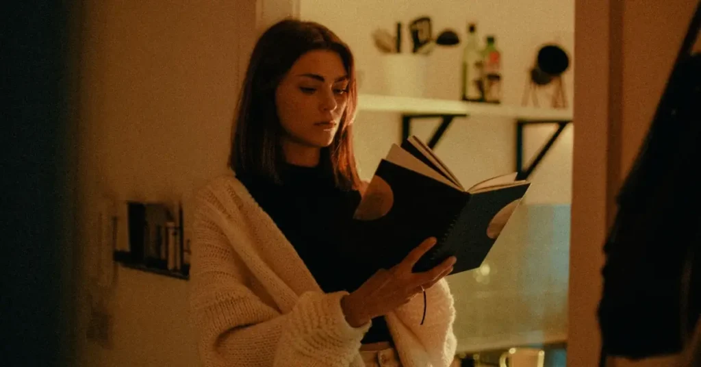 woman reading a dark feminine energy book